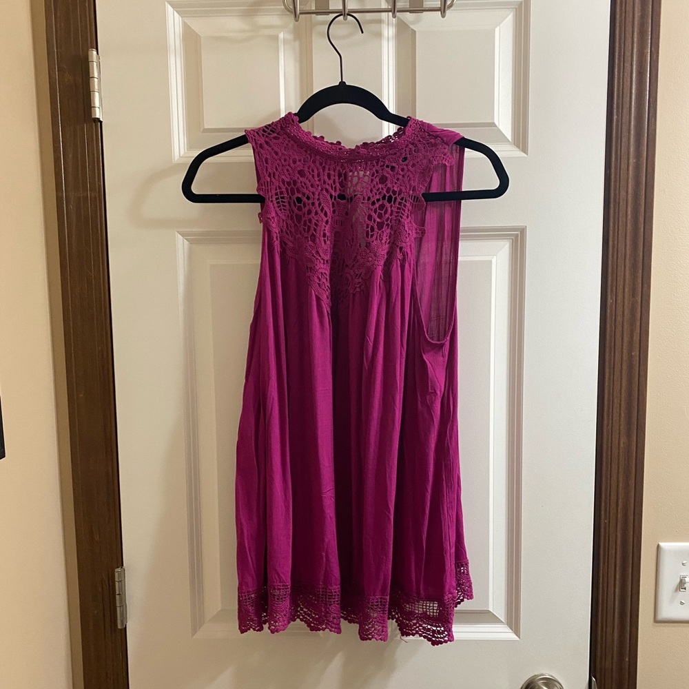 Pink tank with lace embellishment.